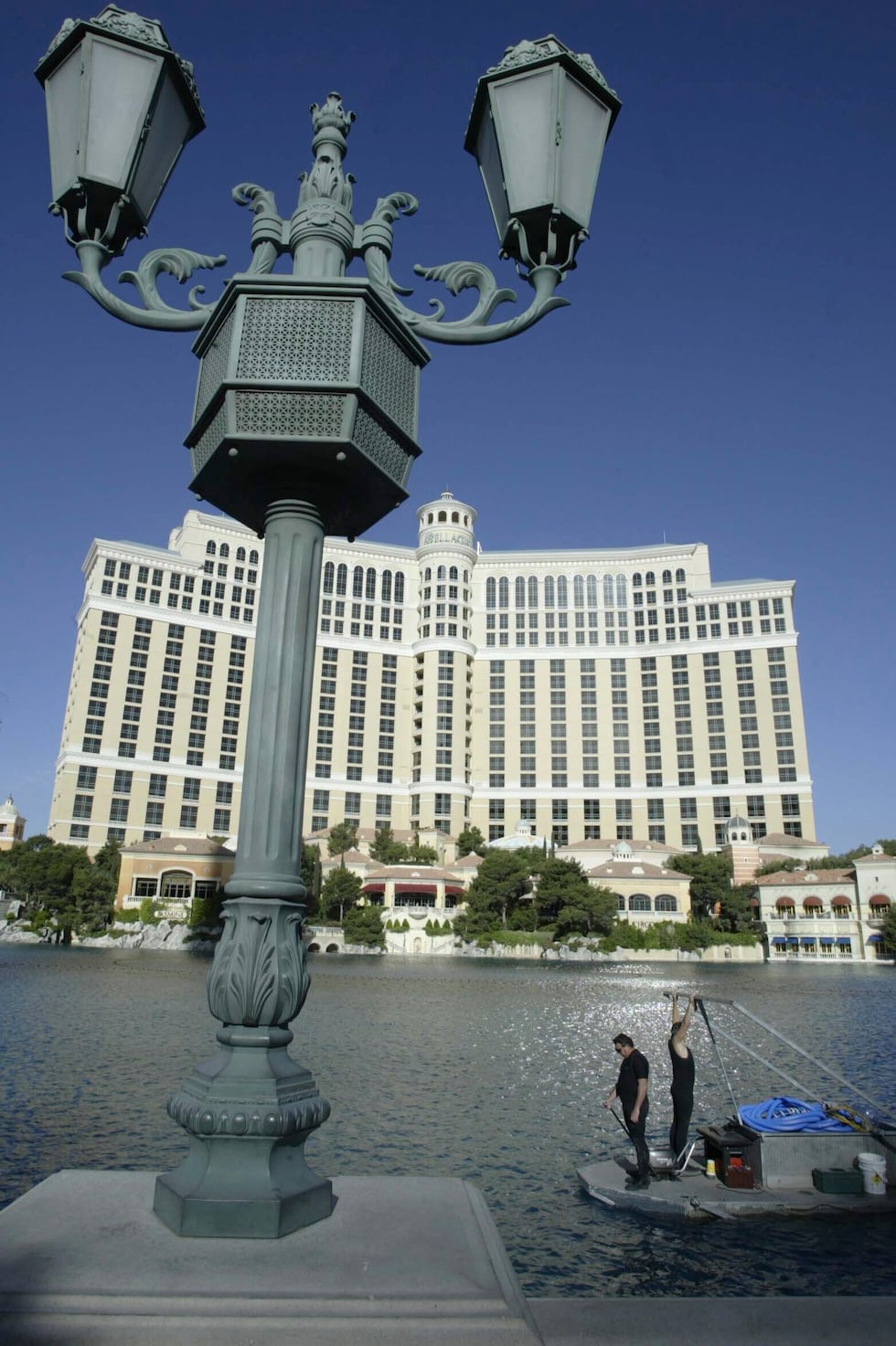 FILE - A crew cleans and tests the fountains at the Bellagio Casino and Hotel resort in Las...