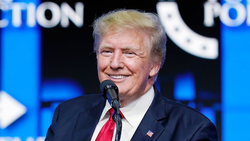 Former President Donald Trump smiles as he pauses while speaking to supporters at a Turning...